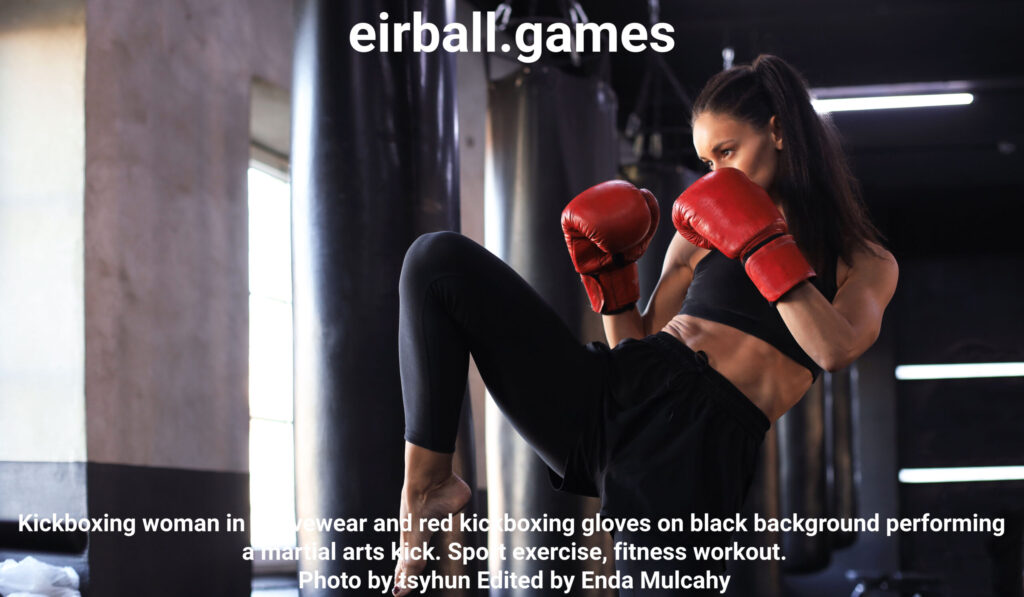 Kickboxing woman in activewear and red kickboxing gloves on black background performing a martial arts kick. Sport exercise, fitness workout. Photo by tsyhun Edited by Enda Mulcahy